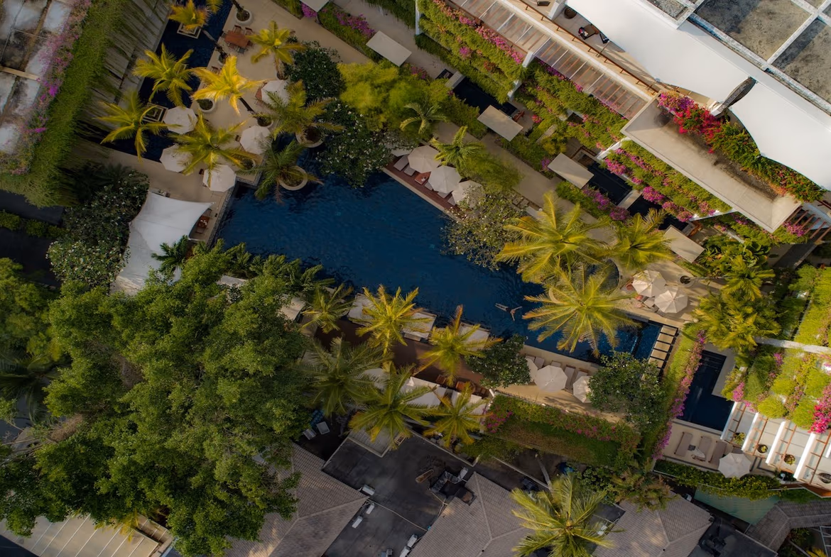 Two-bedroom condominium in Bang Tao with a modern exterior and a balcony overlooking a pool.