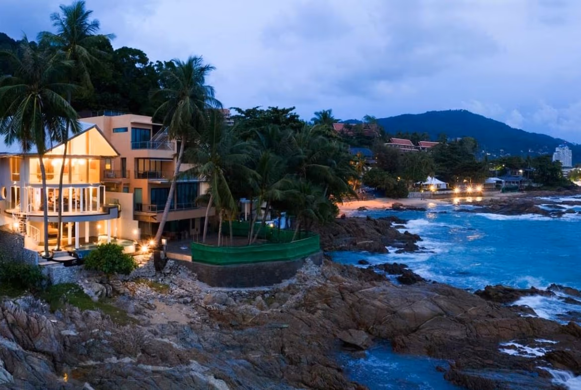 View of a beach and ocean from a balcony or terrace.