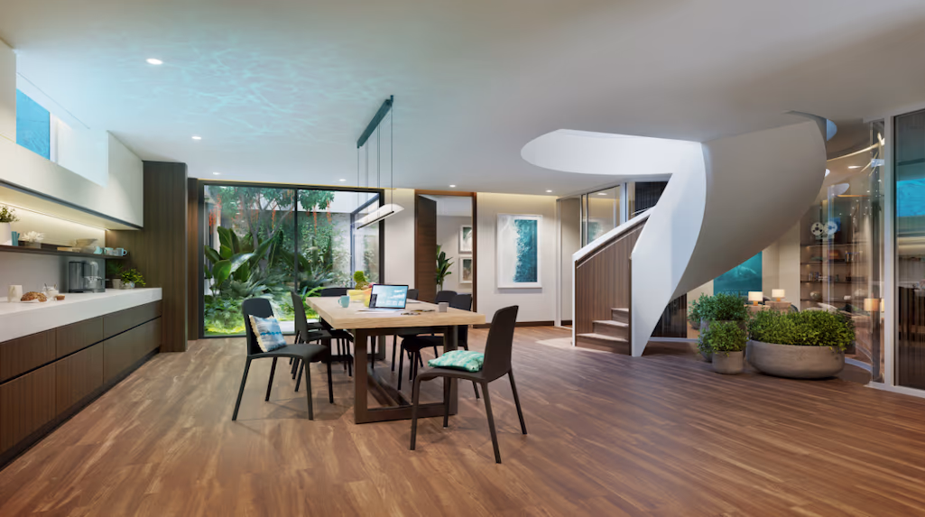 A spacious, modern living room with large sliding glass doors opening onto a patio with a view of the ocean.
