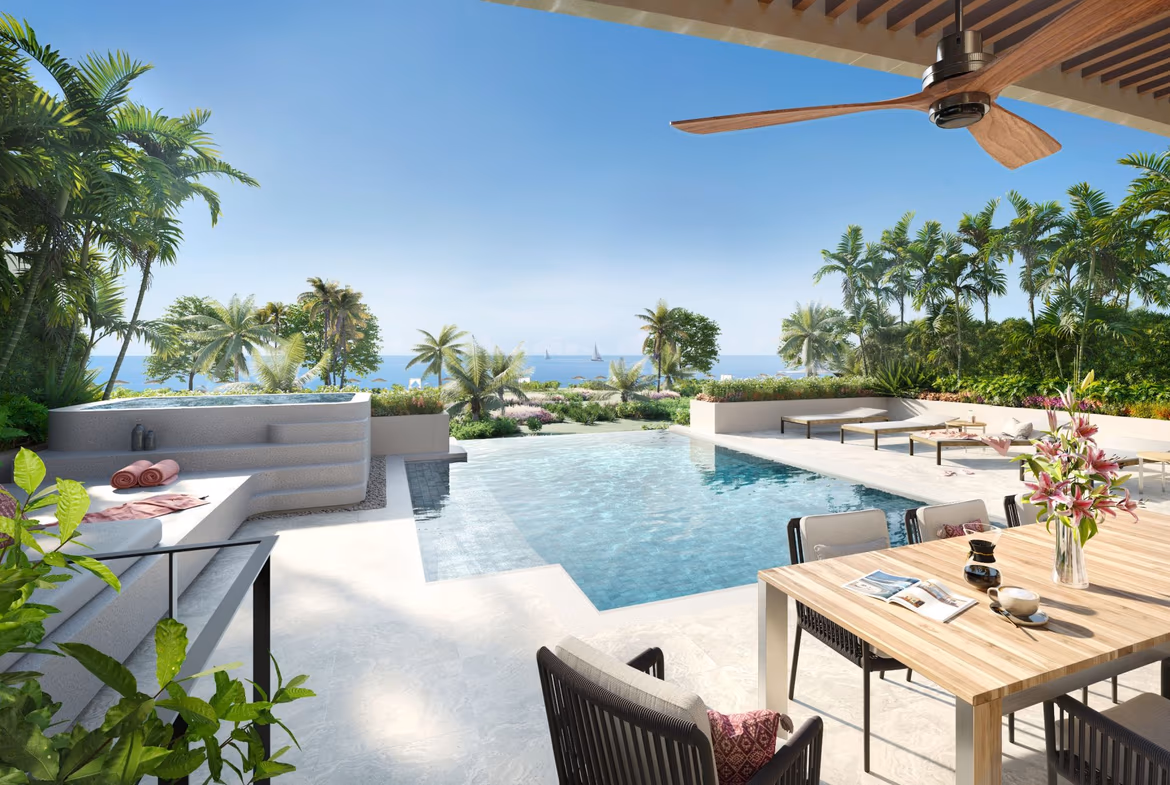 A beachfront villa in Bang Tao with four bedrooms. This photo shows the front exterior of the white stucco building under a clear sky.