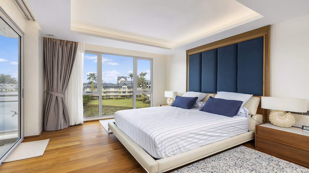 A spacious living room with large windows overlooking the ocean.