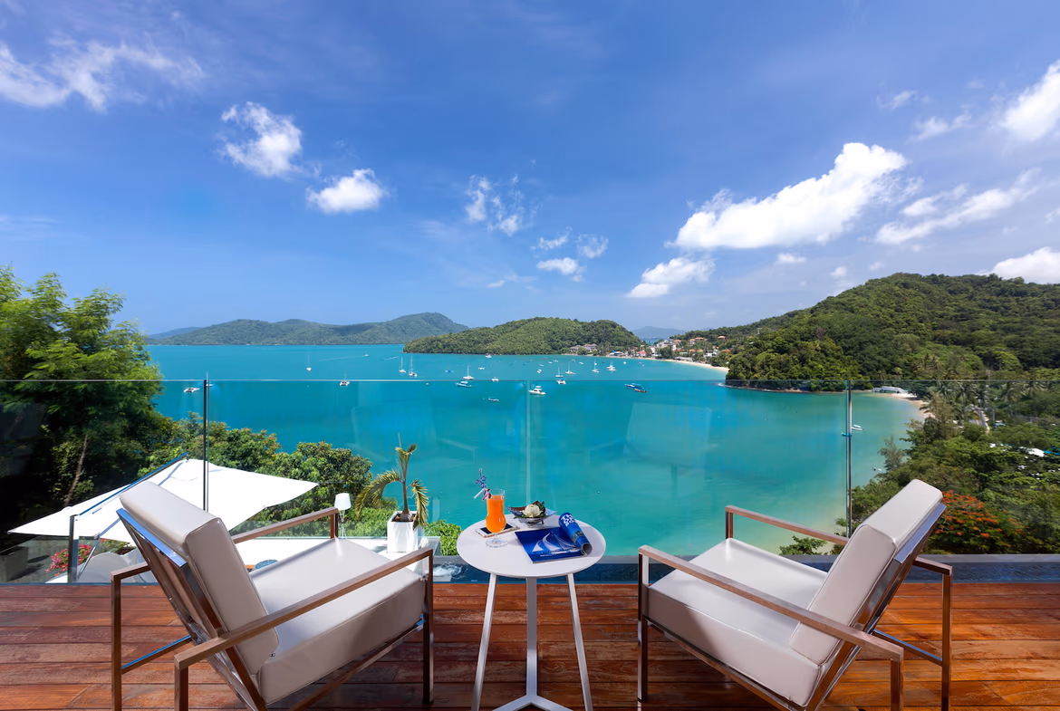 An infinity pool overlooks the ocean and a distant shoreline.