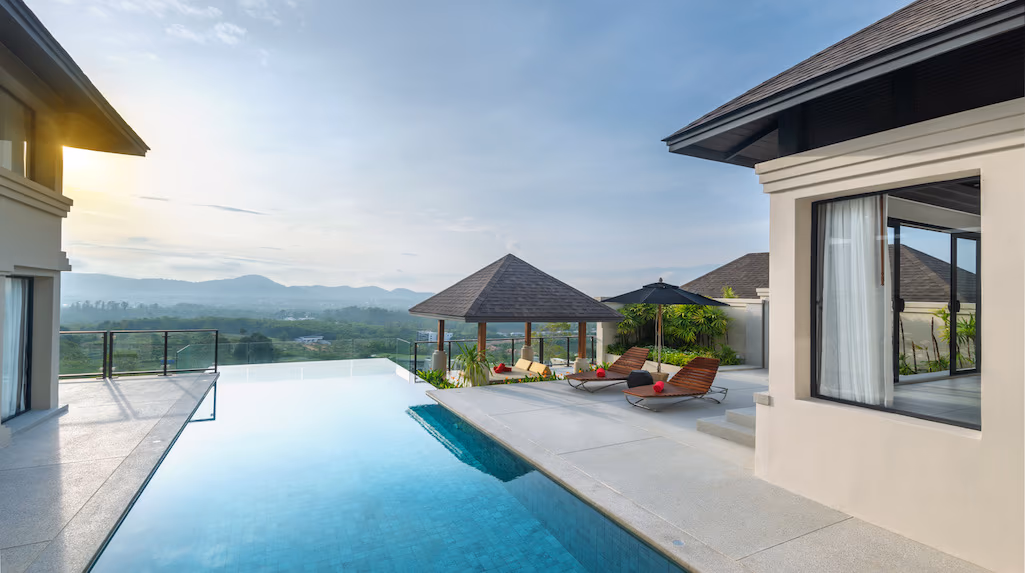 A modern, four-bedroom villa in Laguna features a multi-tiered facade and a private infinity pool overlooking mountain ranges.