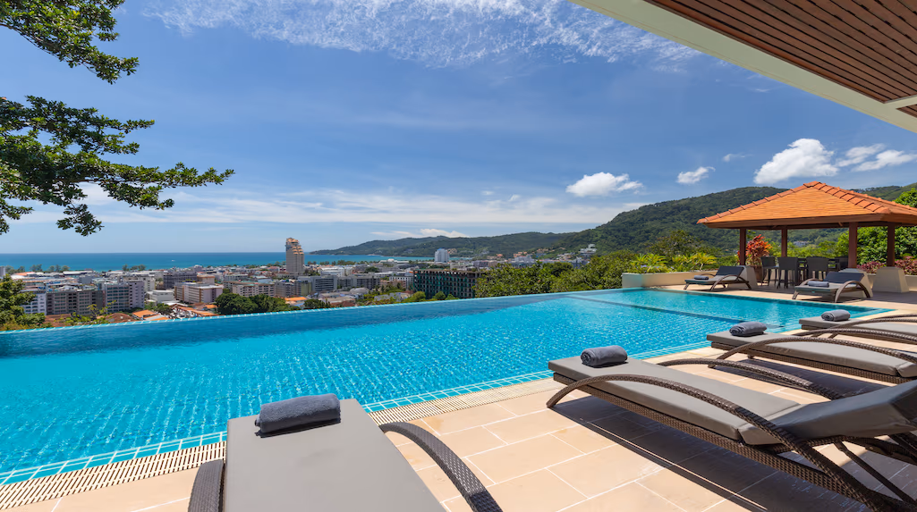 A seven-bedroom villa in Patong with a red tile roof and multiple balconies overlooking the sea.