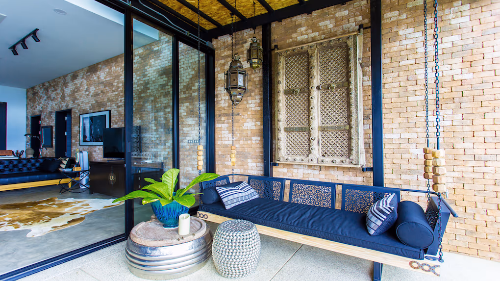 A spacious bedroom offers direct access to a private balcony overlooking the mountains.