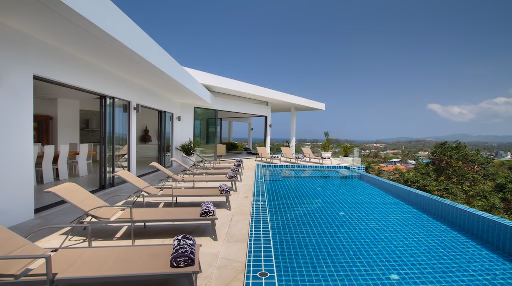 Exterior view of a nine-bedroom villa in Bang Tao, featuring a large swimming pool.