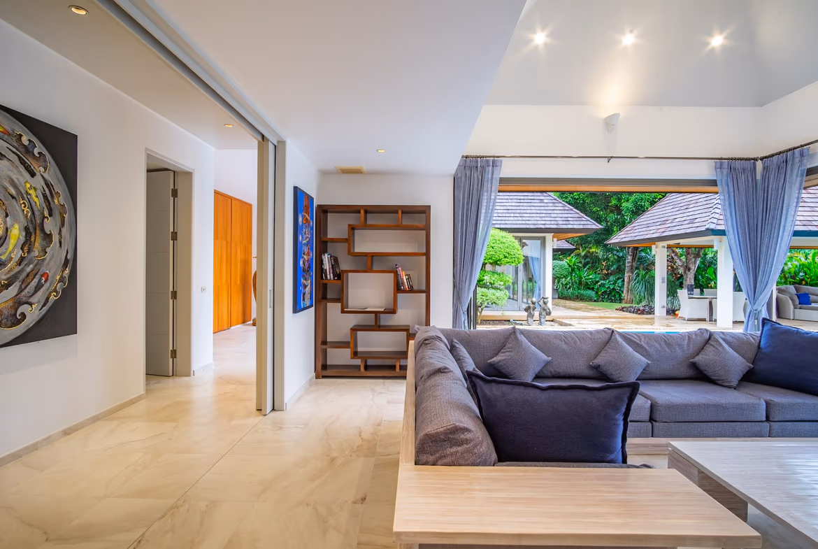 A spacious living area with modern furnishings and large windows.