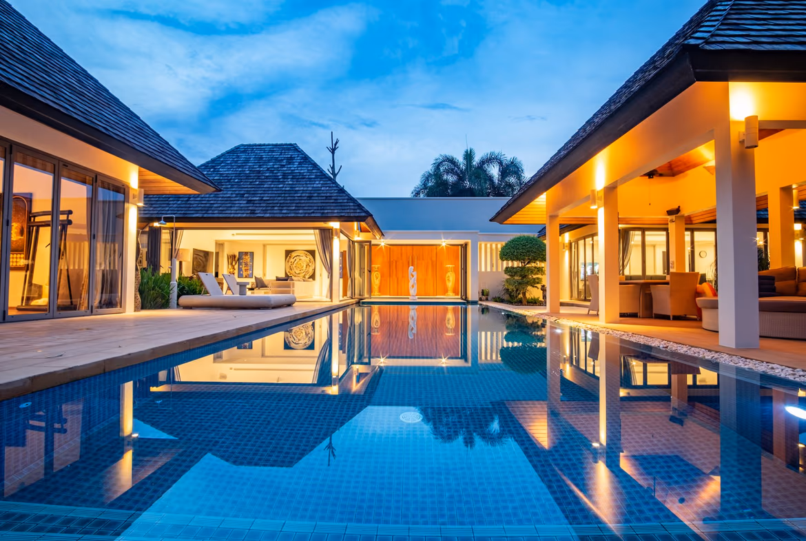 A modern, spacious living area with large glass doors opening to an outdoor space.