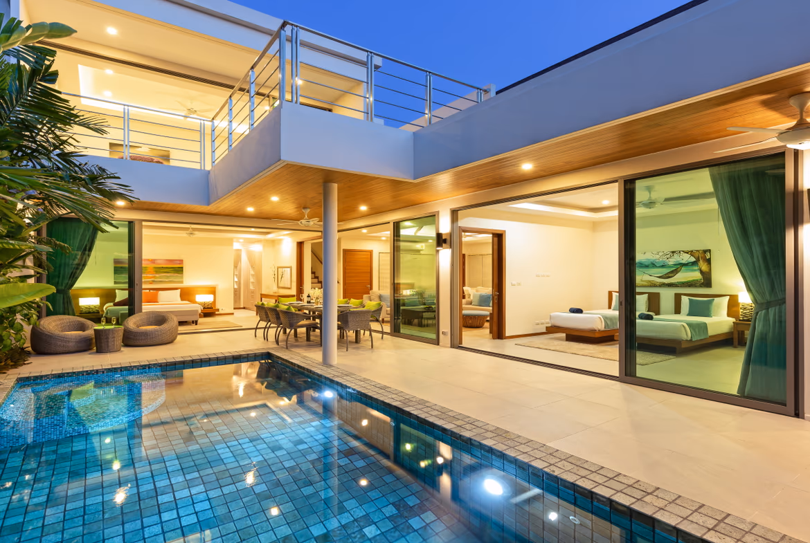A spacious living room with modern furnishings and a view of a patio.