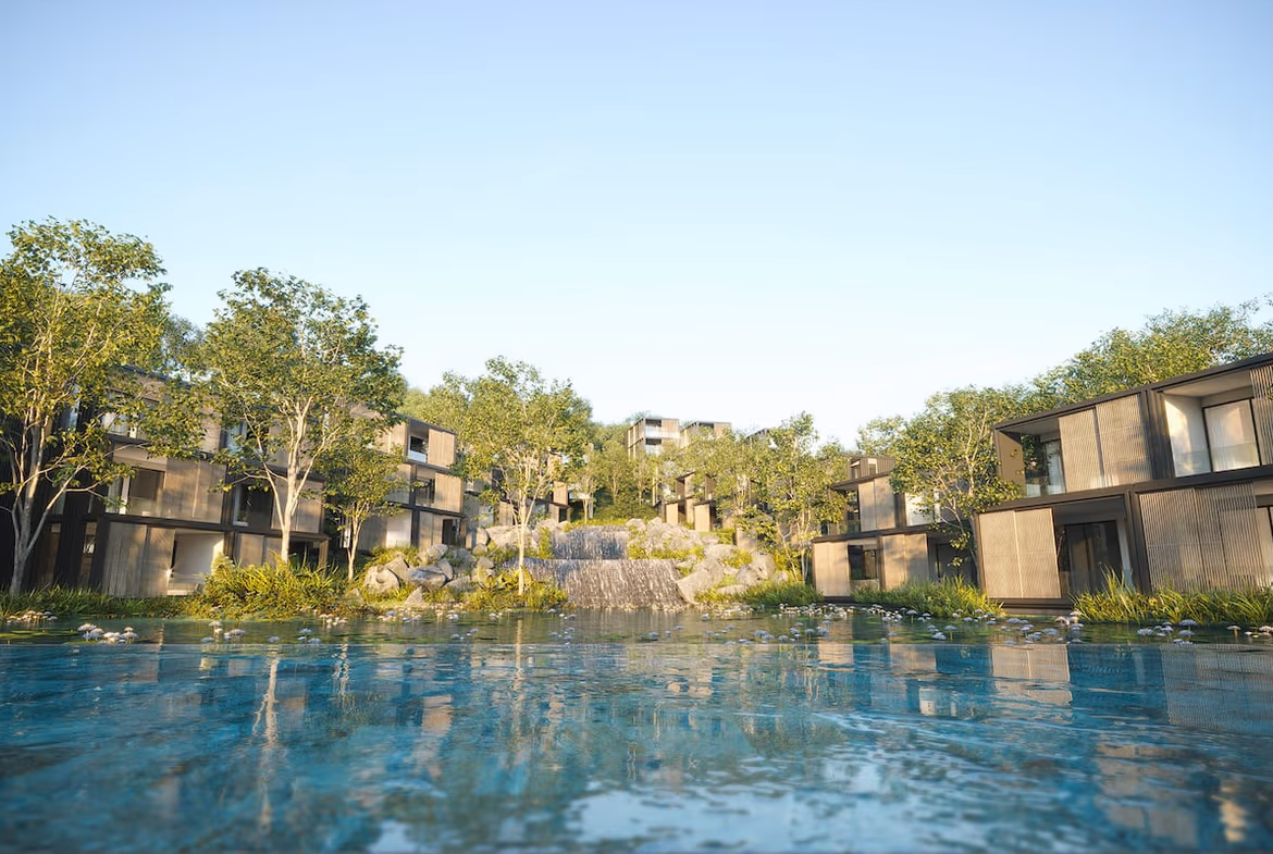 Exterior view of a luxury condominium building in Kamala. The modern building features balconies overlooking a lake.