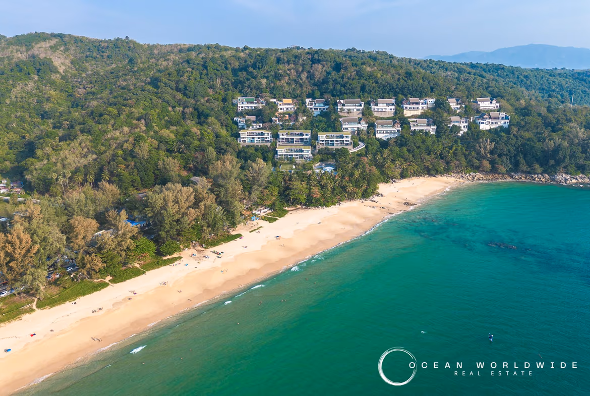 A spacious living room elegantly furnished, offering a panoramic view of the sea.