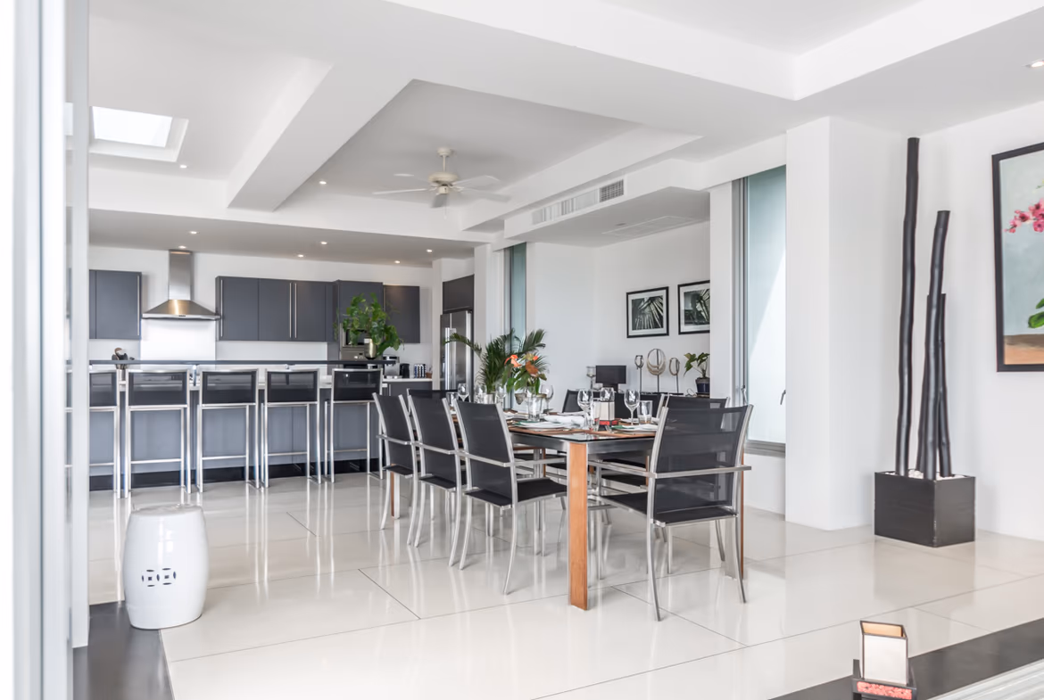 A spacious living room with large windows offering a sea view.
