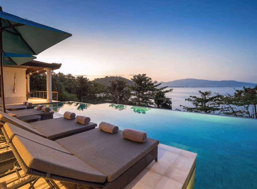 Infinity pool at sunset looking over the sea near Bang Tao