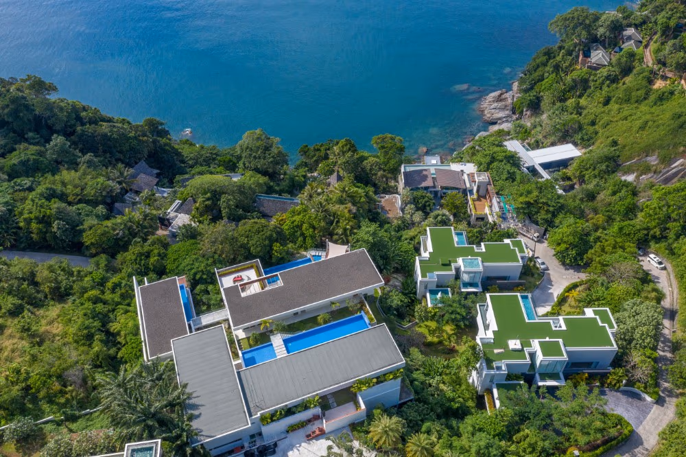 A panoramic shot of the ocean from a high vantage point, showing an infinity pool in the foreground.