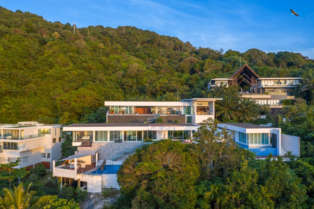 A tropical villa balcony overlooks a wide ocean vista.