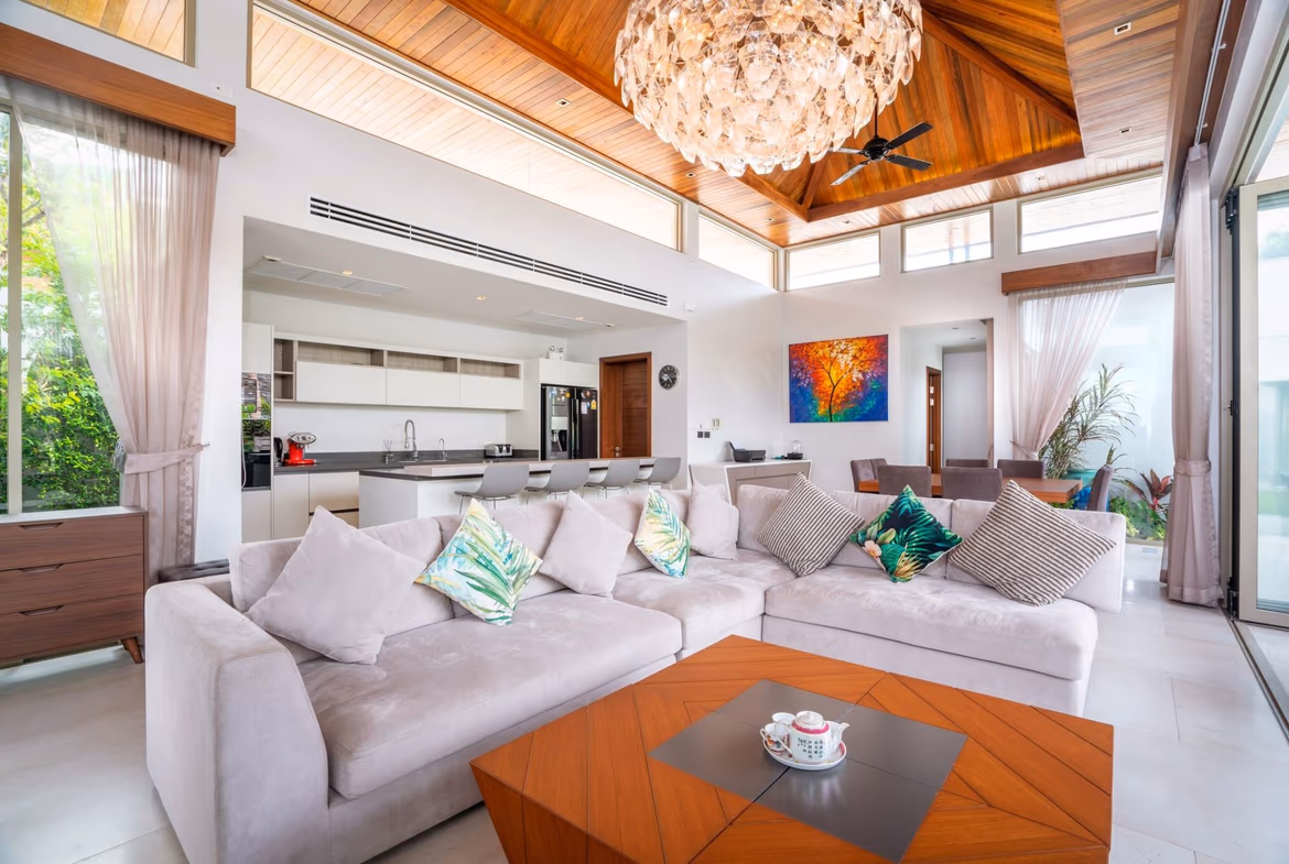 A modern living room with a neutral color palette, featuring a sofa, a coffee table, and an accent chair.