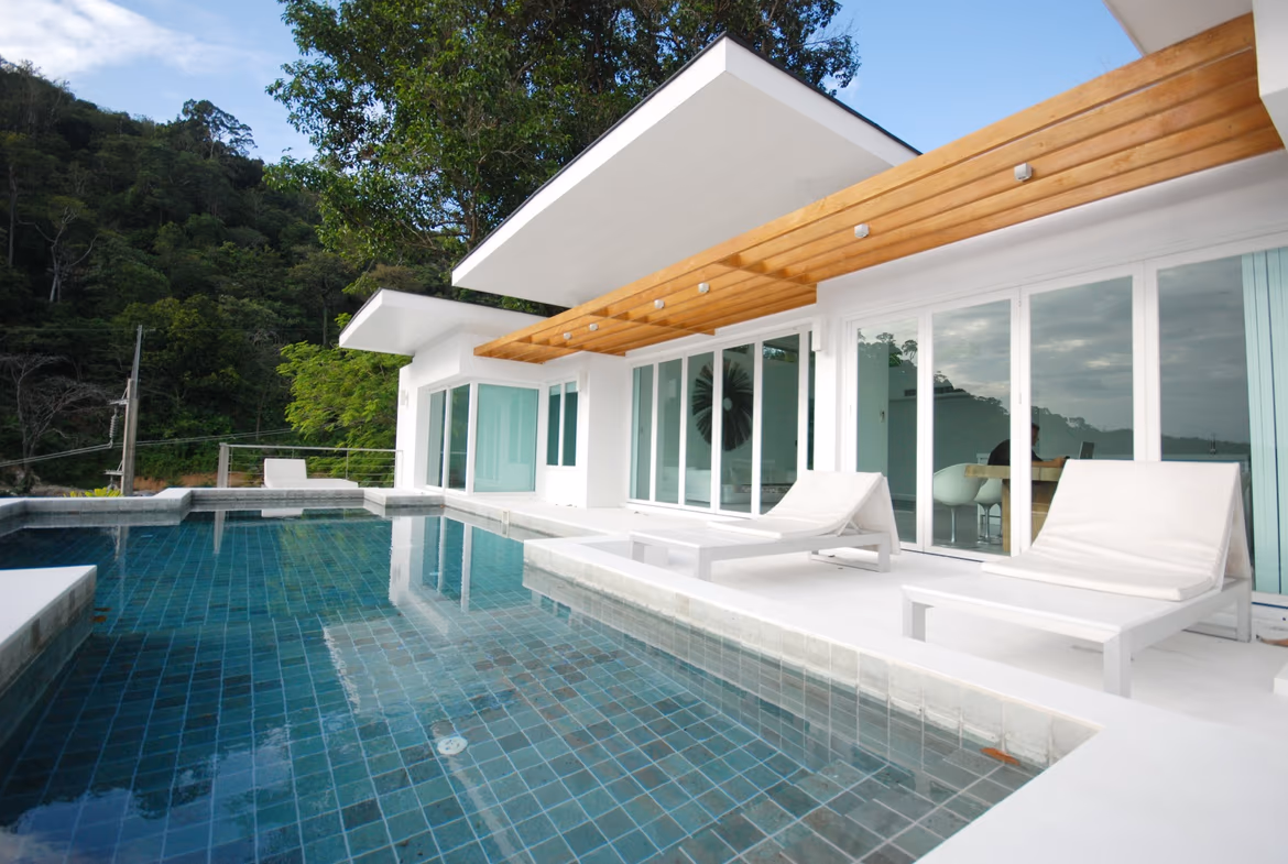 A modern 3-bedroom villa in Kamala features a multi-tiered balcony overlooking the sea.