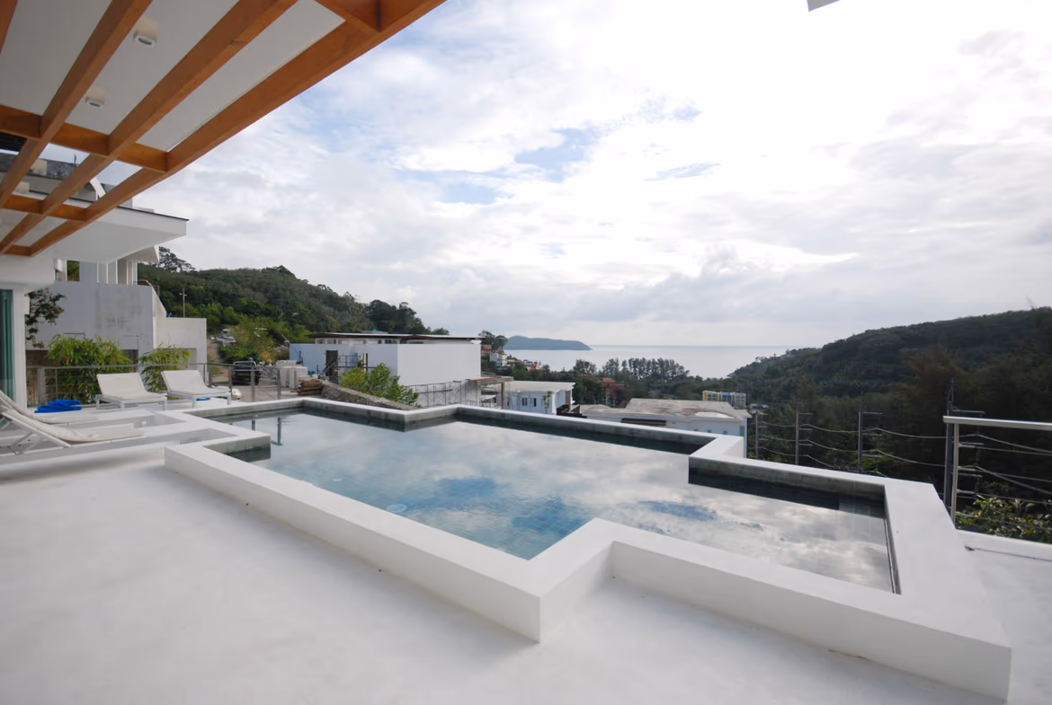 A spacious modern living area with an unobstructed view of the sea through large windows.