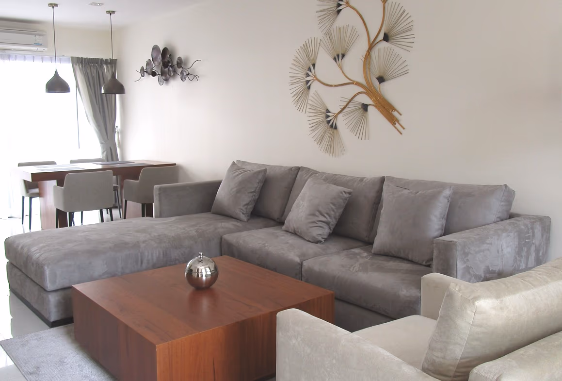 A spacious living room with large windows overlooking a golf course.