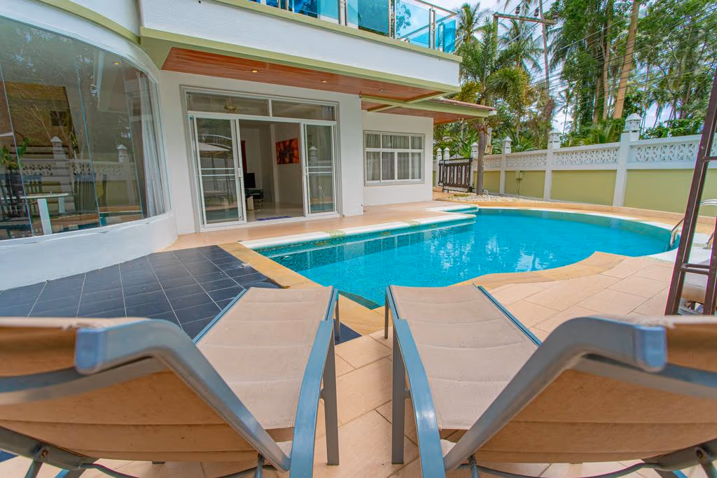 A spacious, open-plan living area with comfortable seating and outdoor access.
