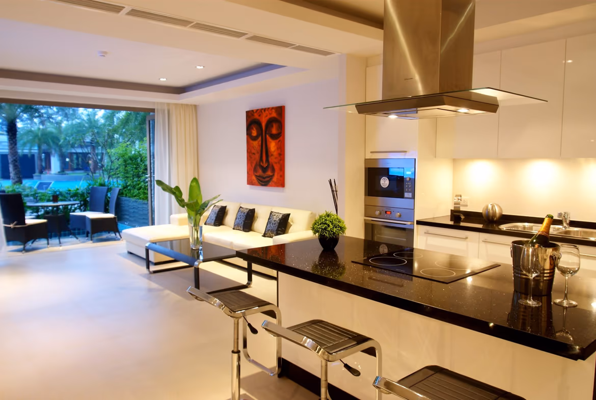 An open-plan living area with modern furnishings and a view of the ocean.