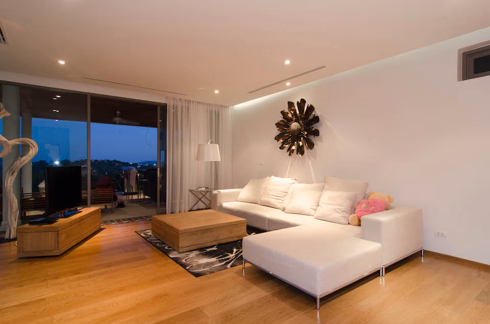 A bright and airy bedroom with a private balcony overlooking a lush garden.
