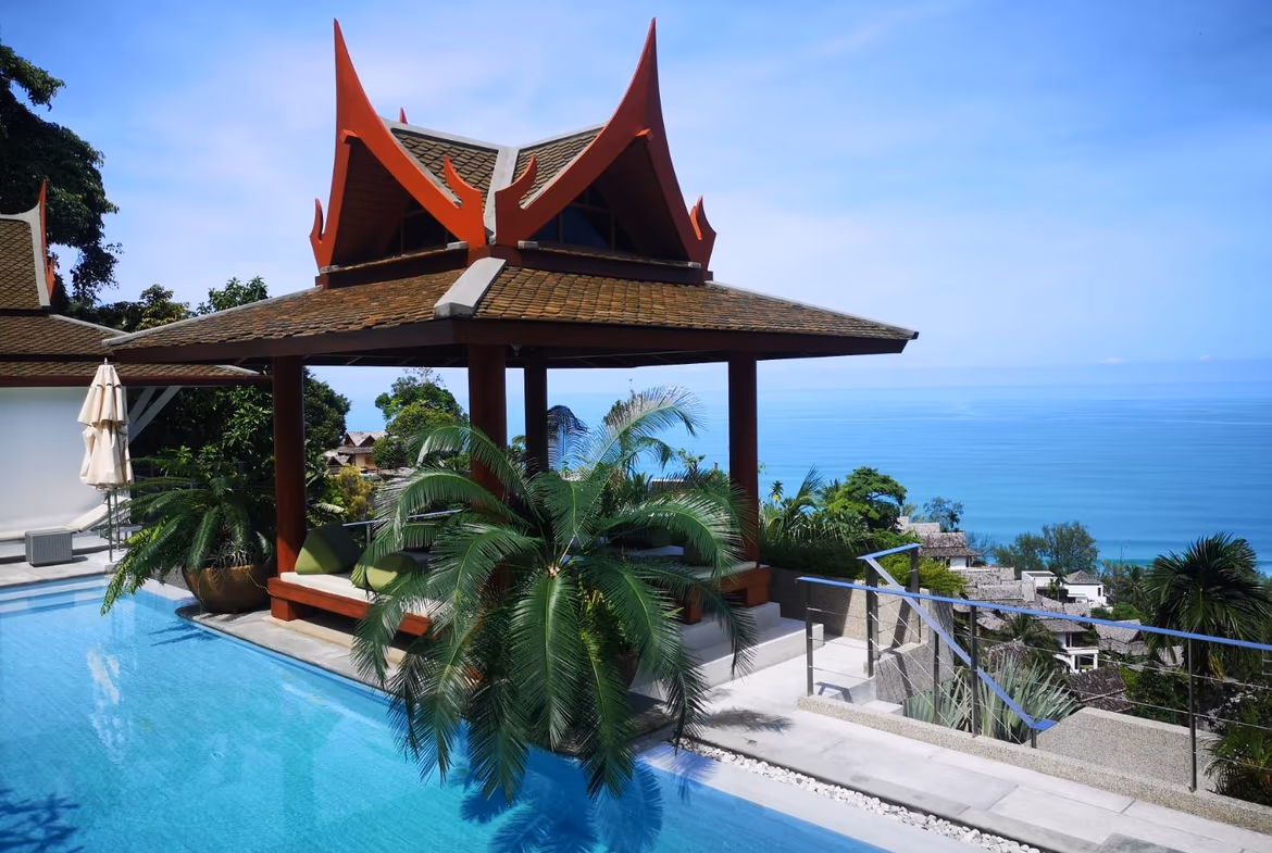 Thai-style gazebo beside an infinity pool overlooking the sea at Surin