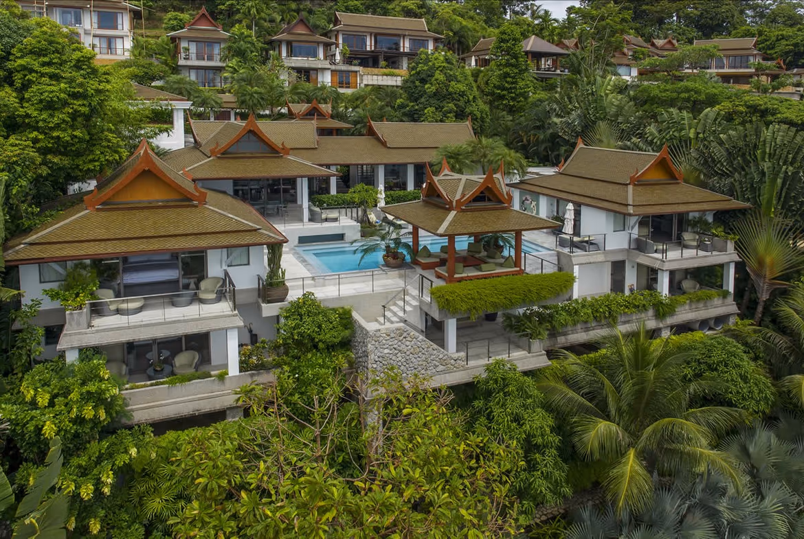 A partial view of an outdoor swimming pool with surrounding patio area.