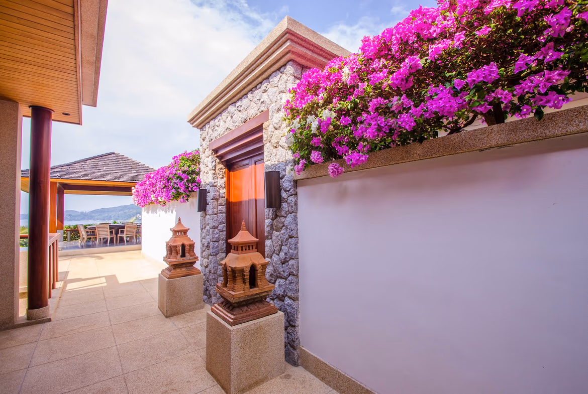 A lavishly decorated living area with a large window overlooking the ocean.