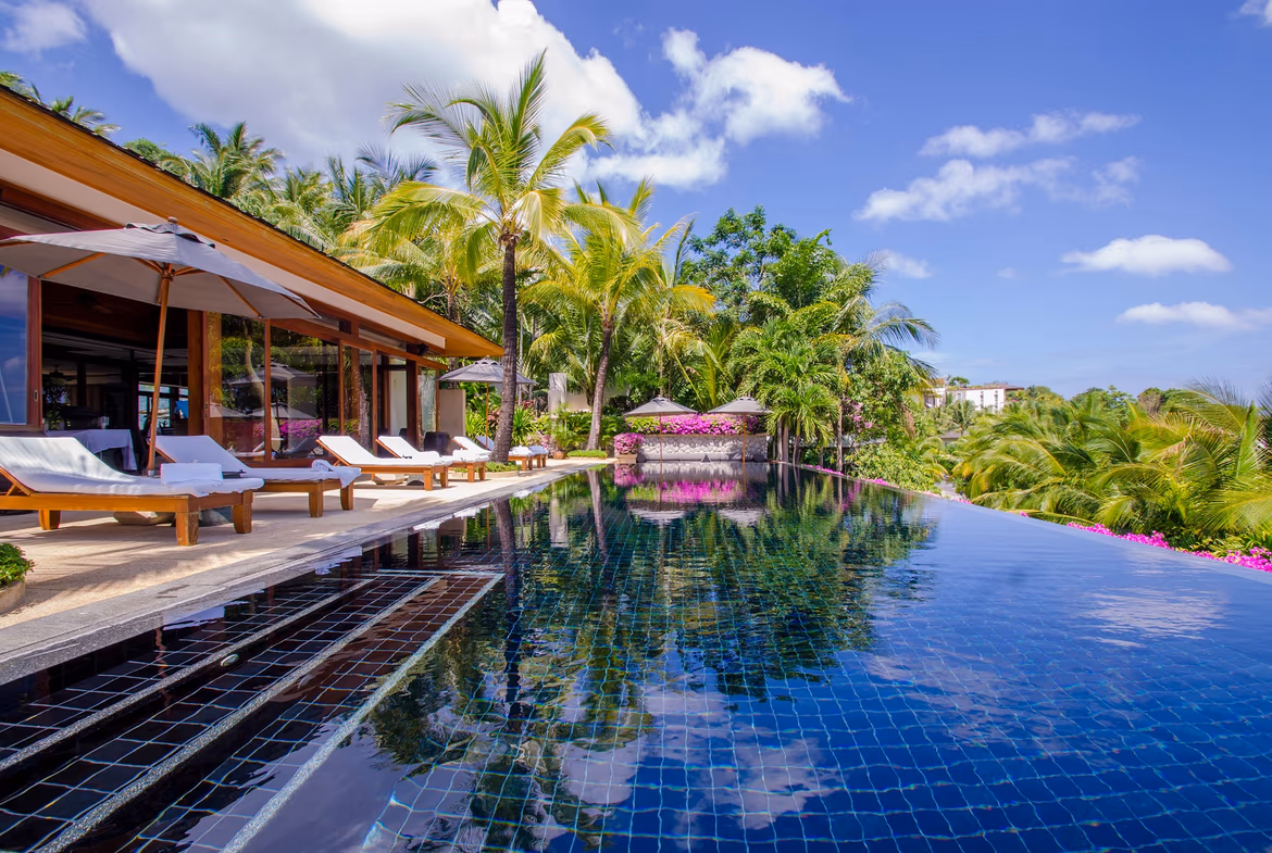 A luxurious bedroom with a panoramic ocean view.