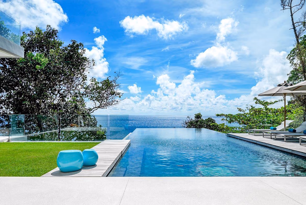 A multi-level, modern six-bedroom villa carved into a cliff overlooking the ocean in Kamala. The villa features extensive outdoor terracing and an infinity pool.