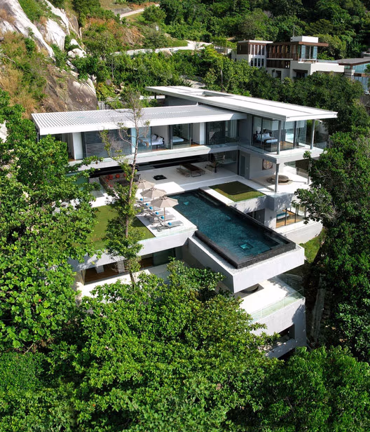 An ocean view from a spacious balcony with a modern glass railing.