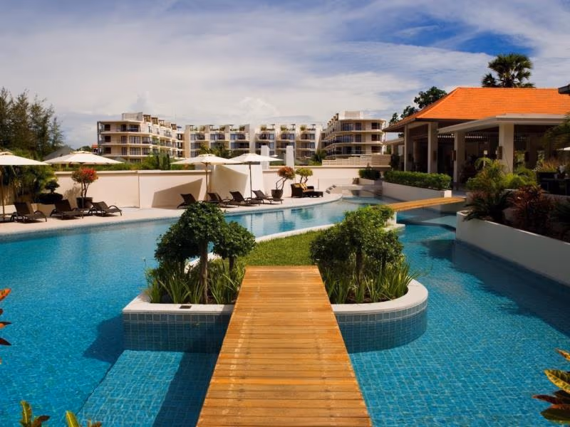 Exterior view of an 85-key hotel in Nai Yang, with palm trees visible on the grounds.