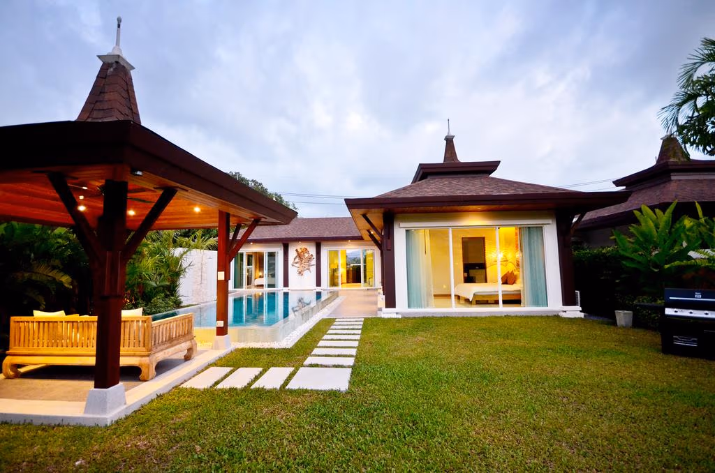 A two-bedroom villa in Bang Tao with a private swimming pool. The property is surrounded by dense tropical foliage.