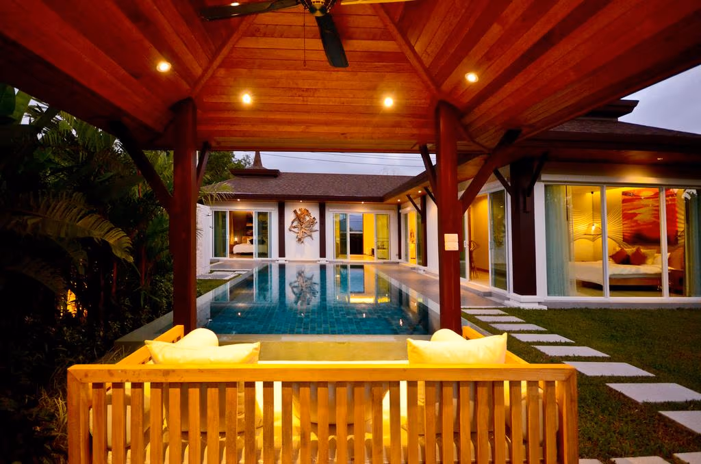 A private swimming pool with sun loungers and a small dining area.