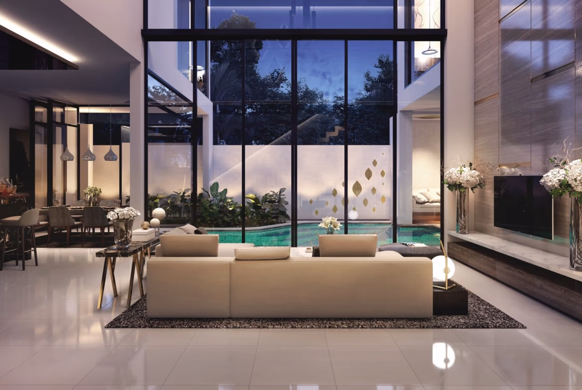 A modern open-plan living area with light furniture and large windows overlooking a patio and ocean.