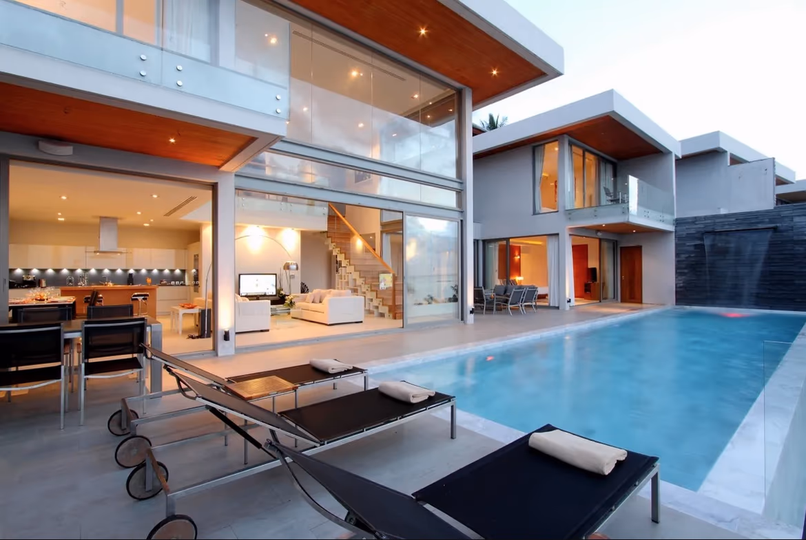 A spacious living area with modern furnishings and a view of the ocean.