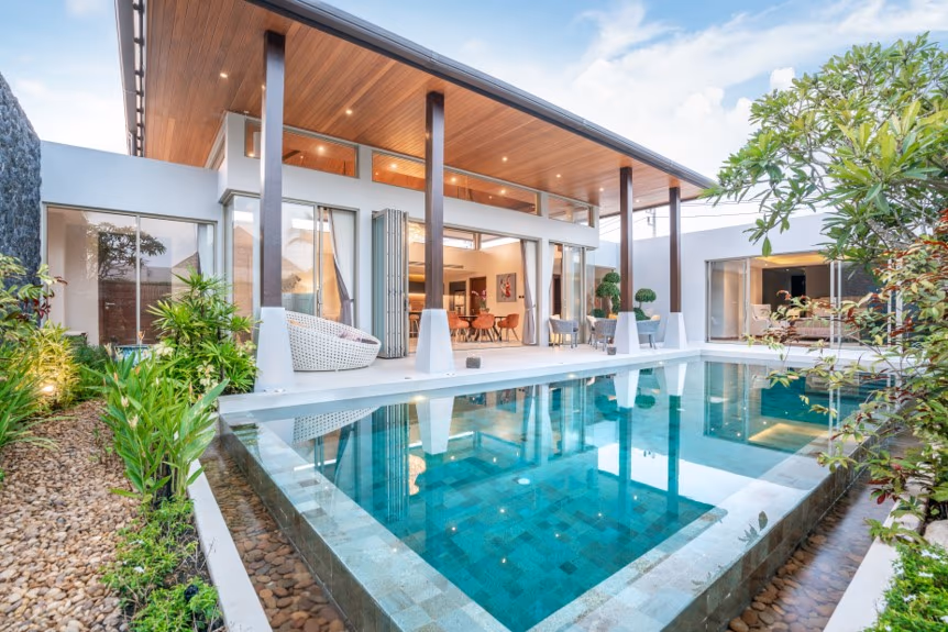 Exterior of a modern 3-bedroom villa in Cherngtalay, featuring a private pool. The villa has a clean, minimalist design with a low-slung roof.