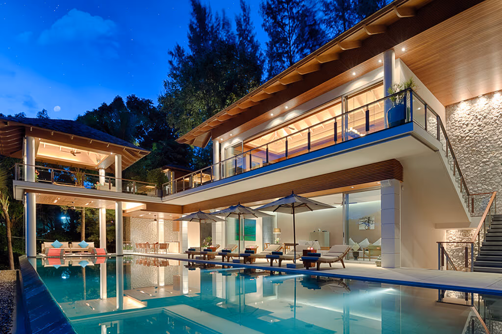 Modern villa and pool lit at twilight in Kamala