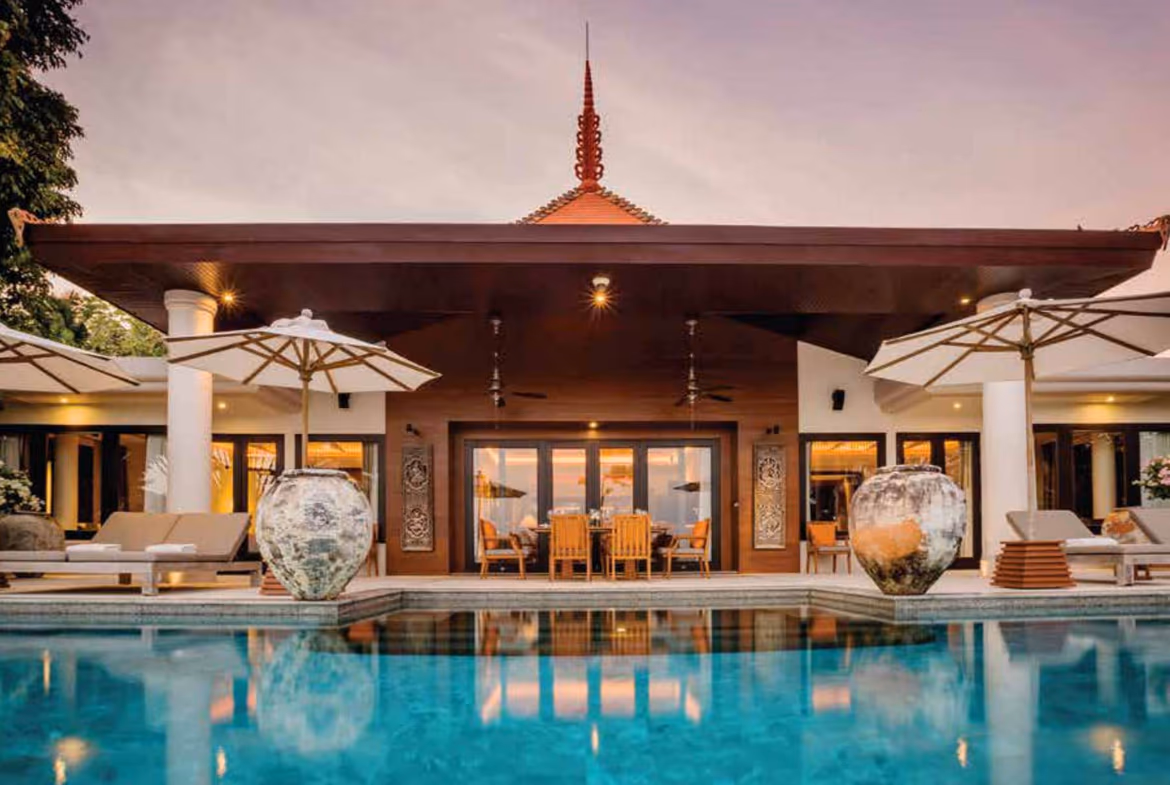 Thai pavilion beside a still pool at dusk, Layan