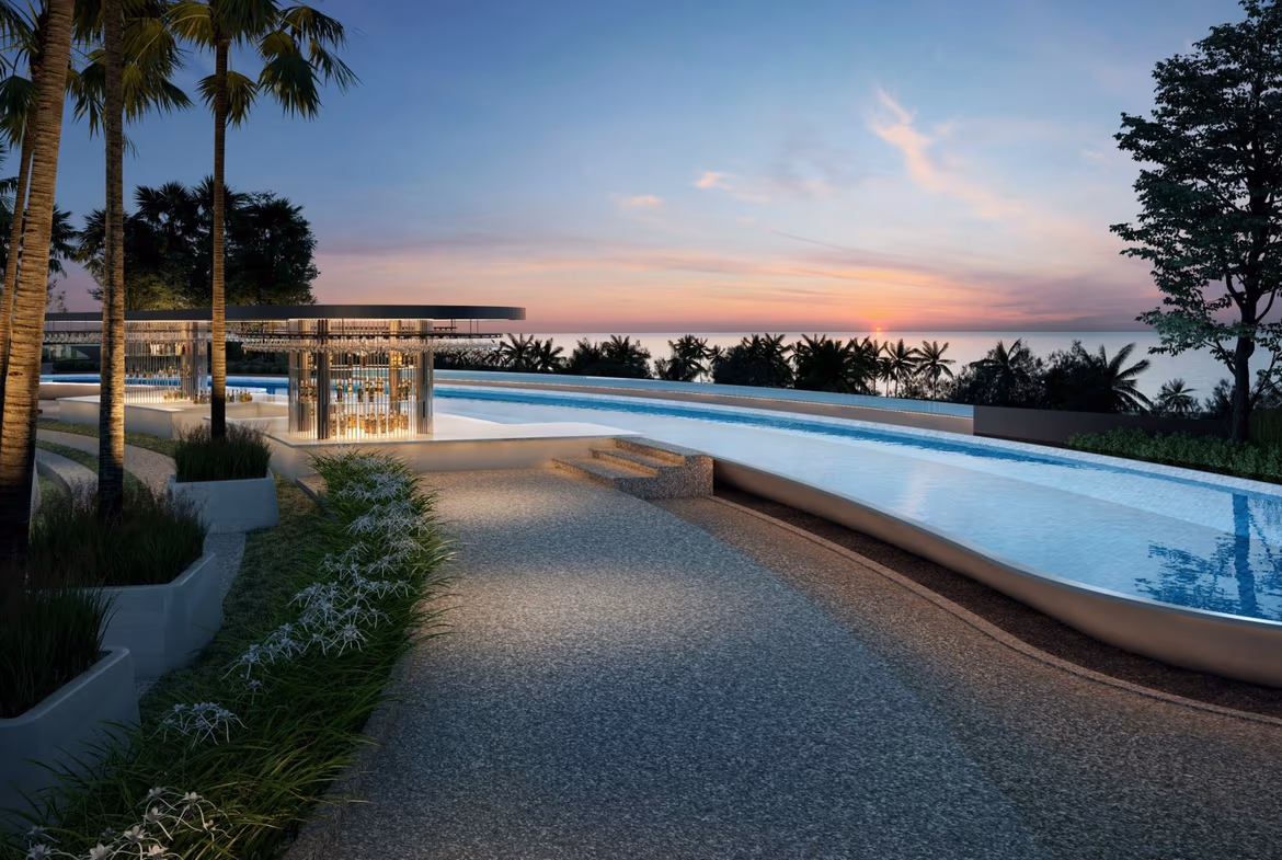Condominium exterior in Bang Tao. The building has a modern facade with large windows and balconies, overlooking a lush garden area.