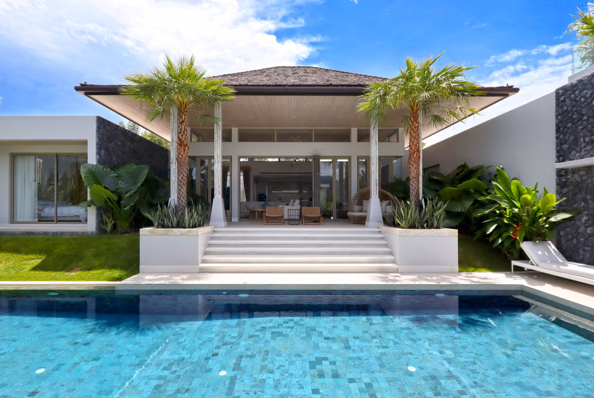 A light-filled living area with vaulted ceilings opens to a private pool and tropical garden.