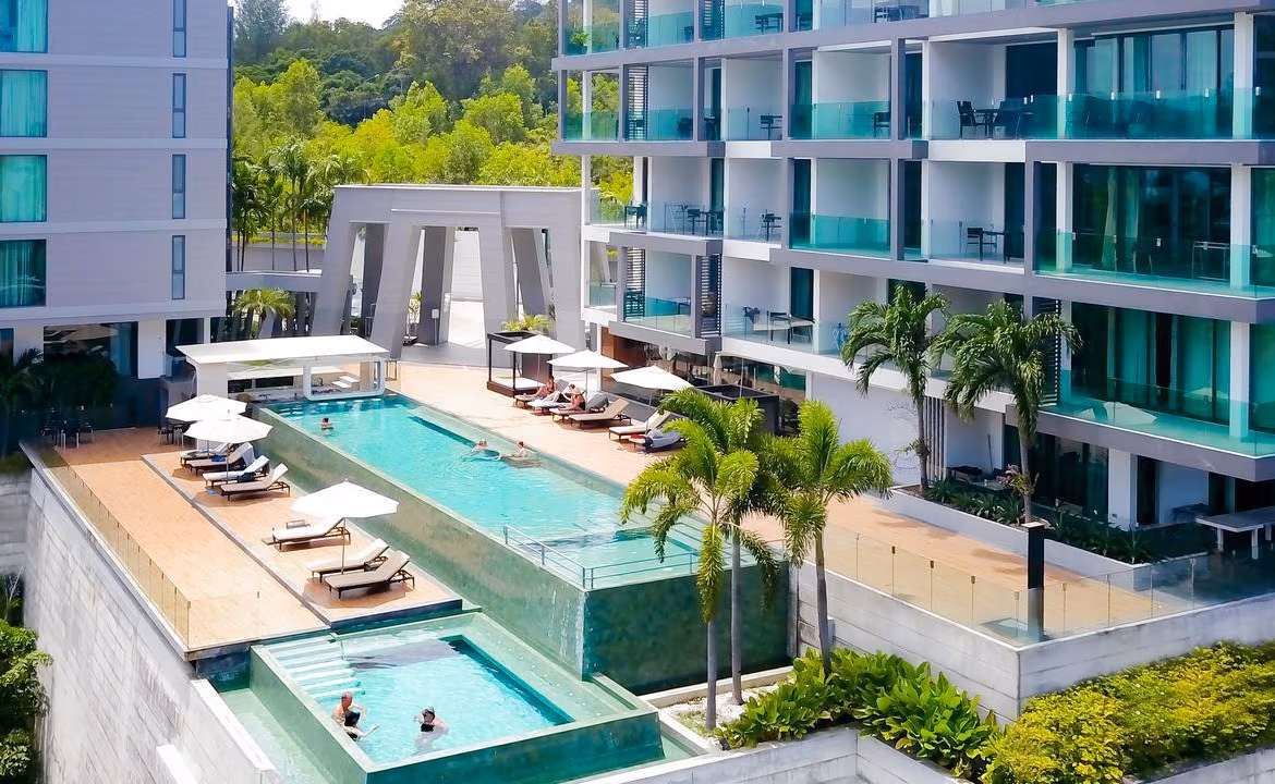 A bedroom with a large window likely offering a view of Patong Beach or Kamala.