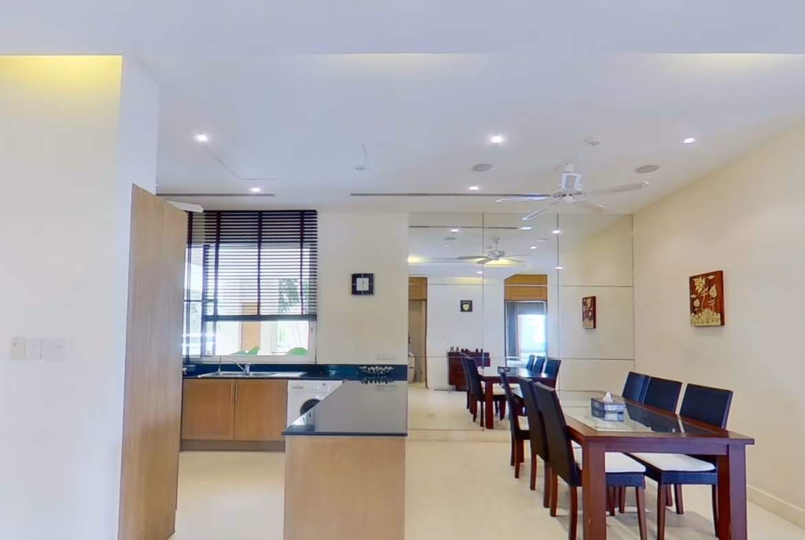 A modern kitchen with light wood cabinetry and stainless steel appliances.