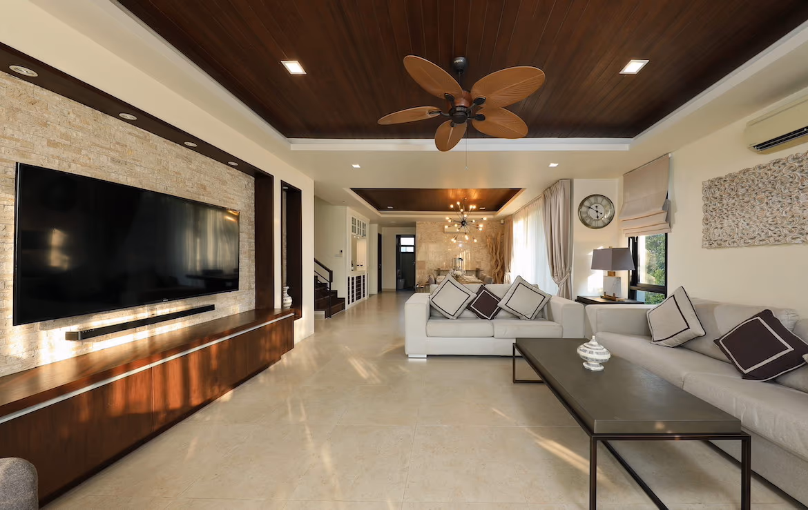 A spacious, modern living room with comfortable seating and a large TV.