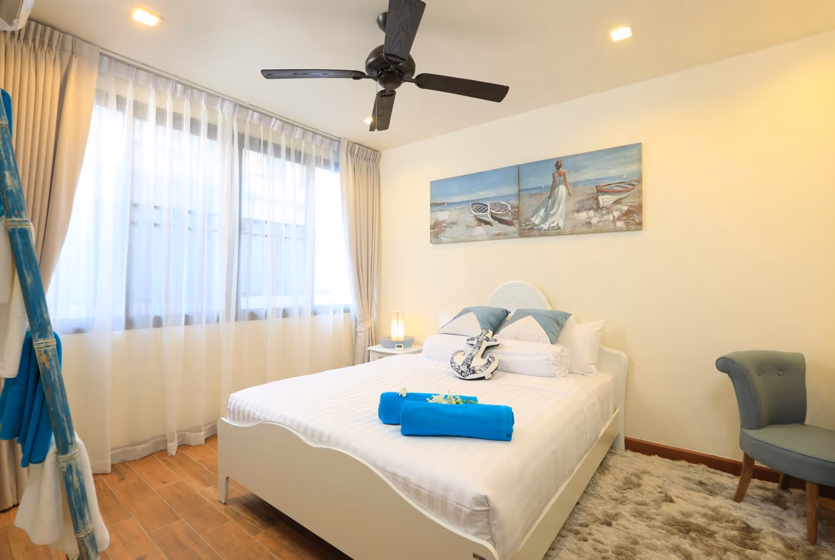 A bedroom with a bed and a view outside.