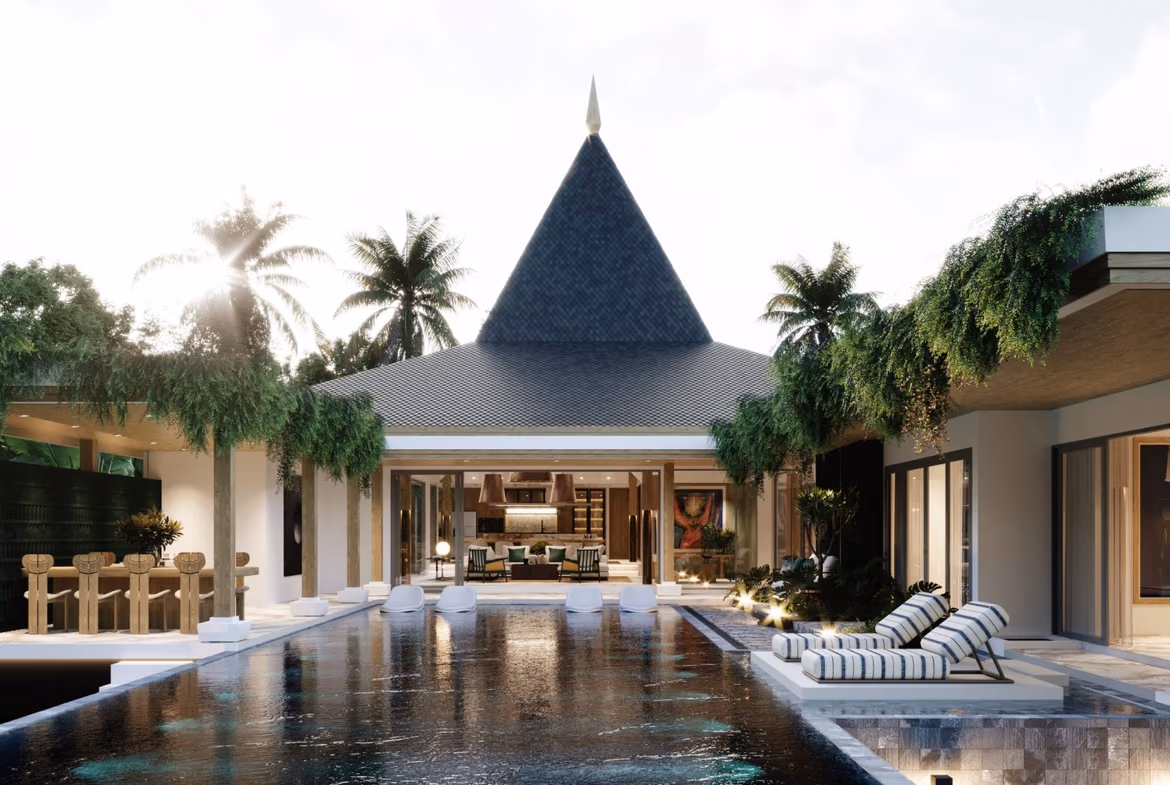Exterior view of a villa in Bang Tao with a tropical garden. The modern white villa is surrounded by palm trees and lush greenery.