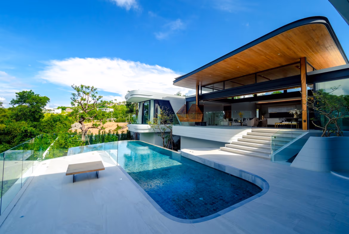 A spacious, modern living area with an open-plan design and large windows.