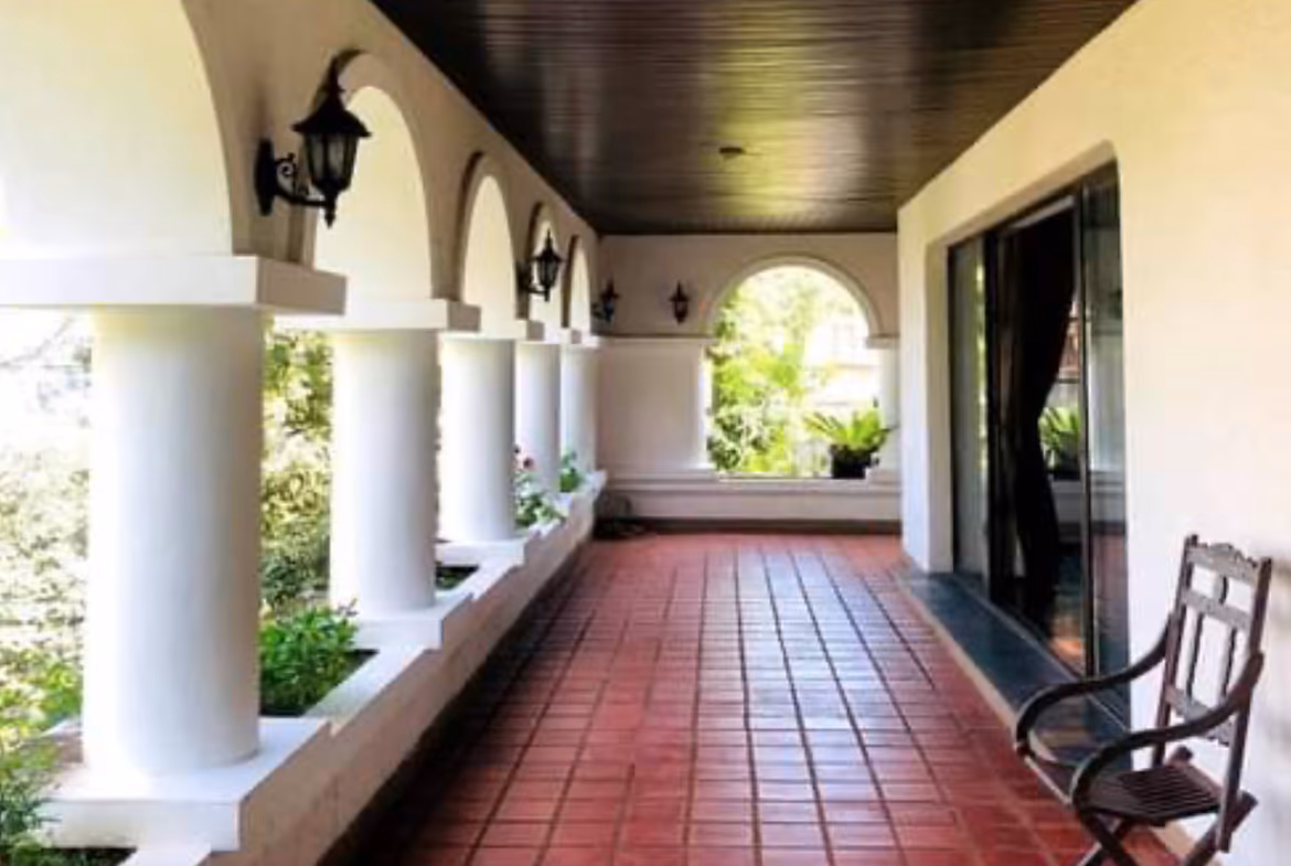 Exterior of a Mediterranean-style, 5-bedroom villa in Karon, featuring a multi-layered entrance and a view of the sea.