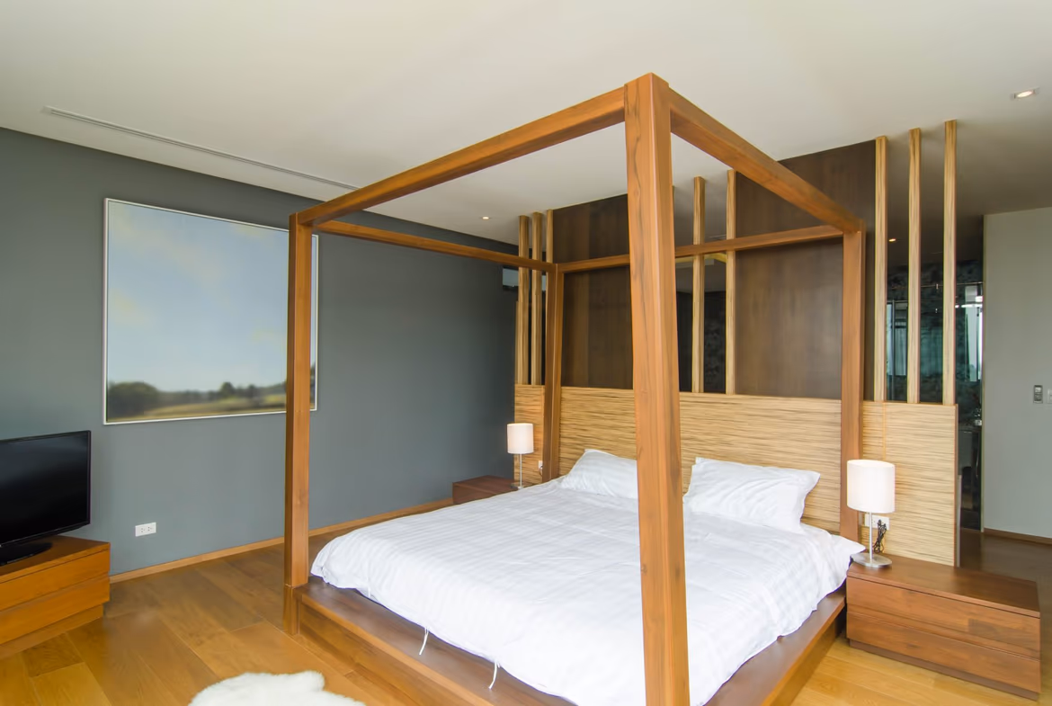 A spacious, well-lit living area with modern furnishings and a view of a lush garden.